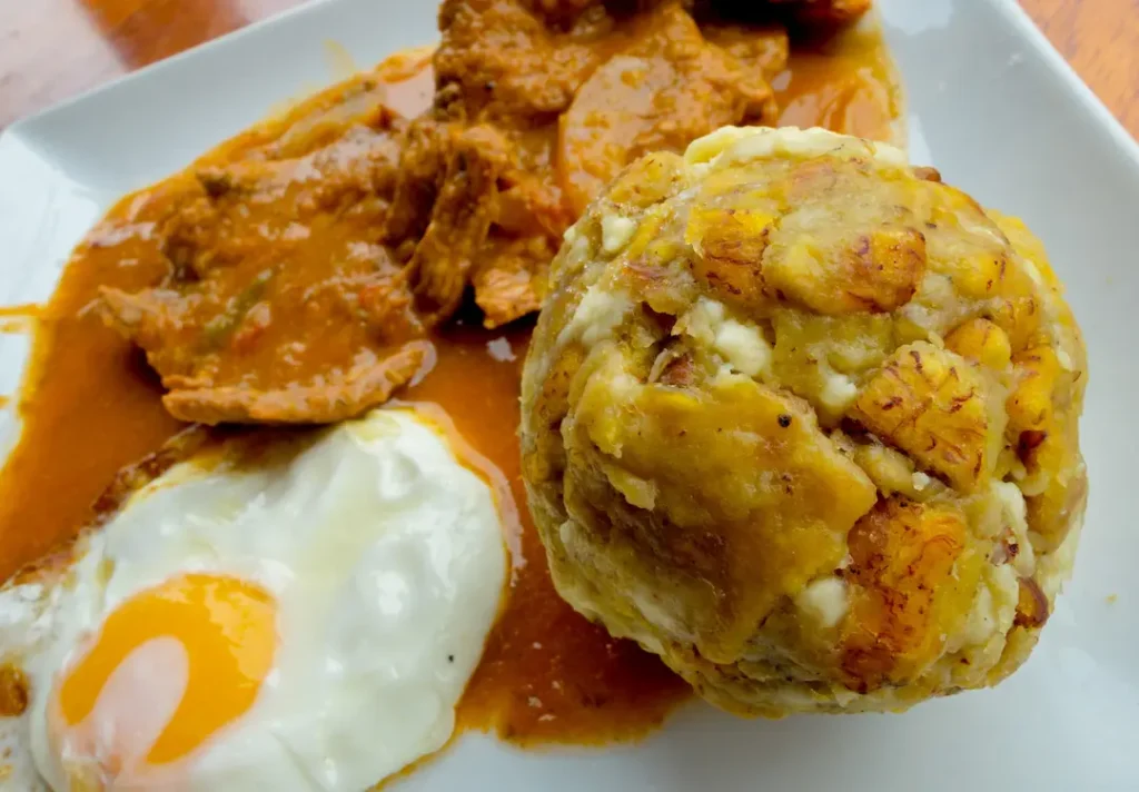Bolón de verde servido como desayuno tradicional en Manta con acompañamientos típicos